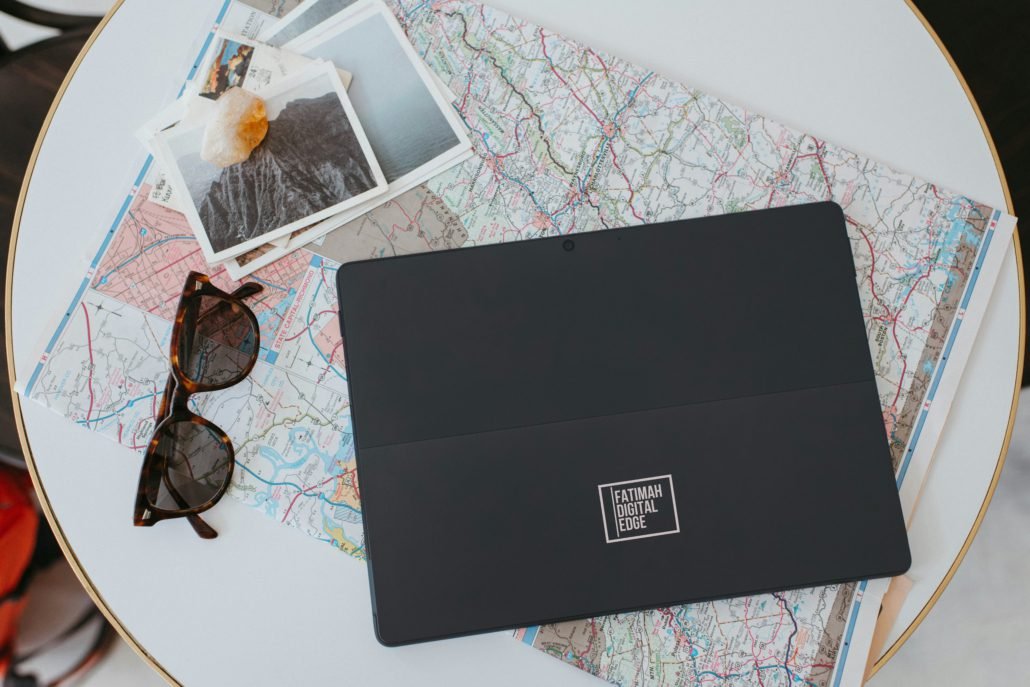Fatimah Digital Edge Branded Tablet on Travel Map Flatlay Fatimah Digital Edge Branded Tablet